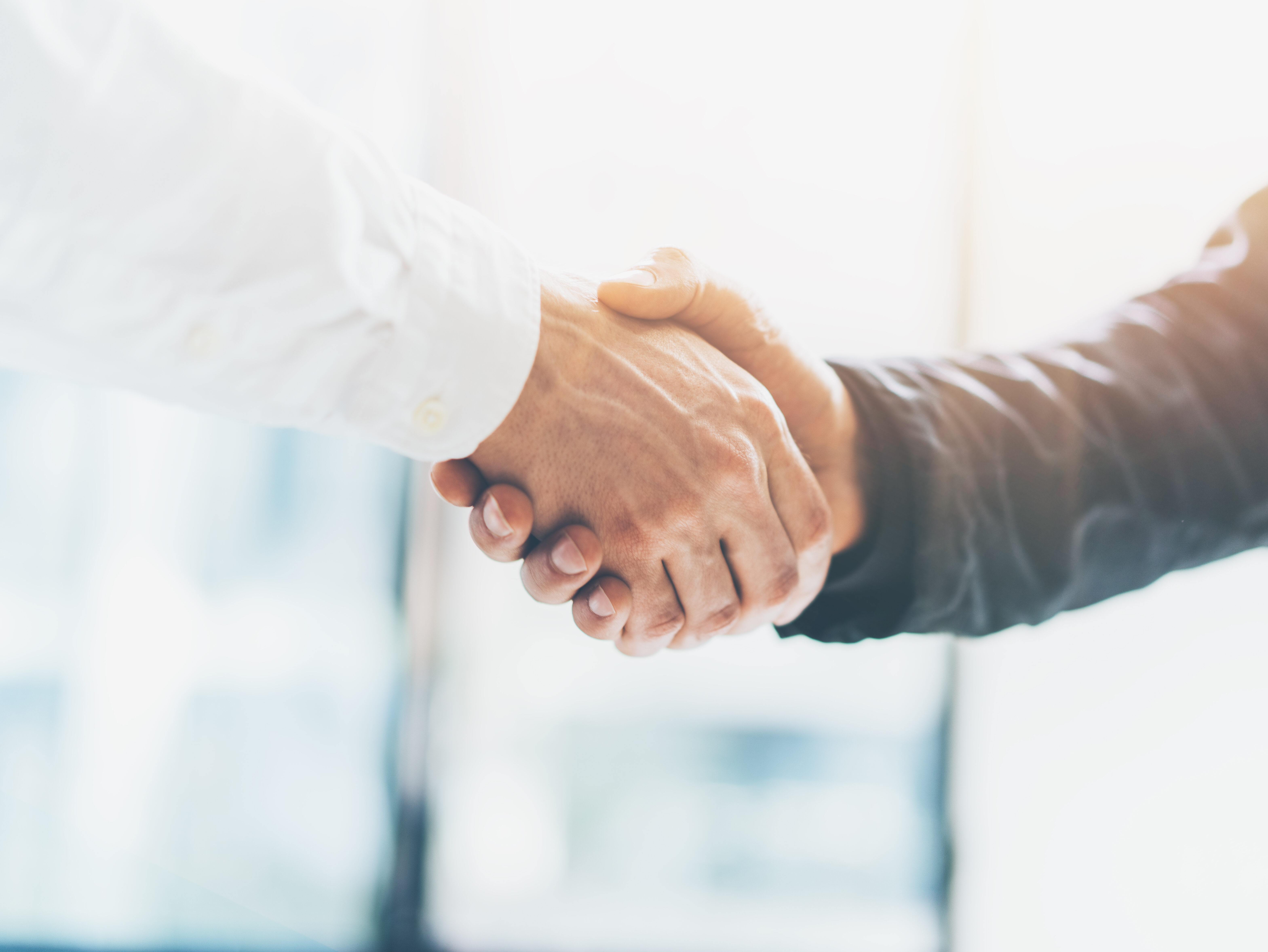Business partnership meeting. Picture businessmans handshake. Successful businessmen handshaking after good deal. Horizontal, blurred background